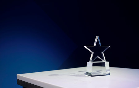 Star-shaped award on a table with spotlights and copy spaceの写真素材