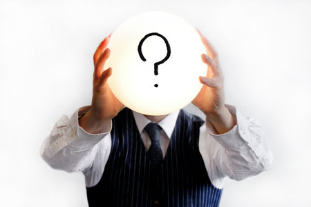 Question mark in a glowing bubble held by a man in a shirt and tieの写真素材