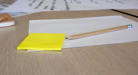Sticky notes, papers and a pencil during a brainstorming session at a business workshop