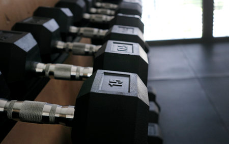 Selective focus on a row of weights in a gymの写真素材