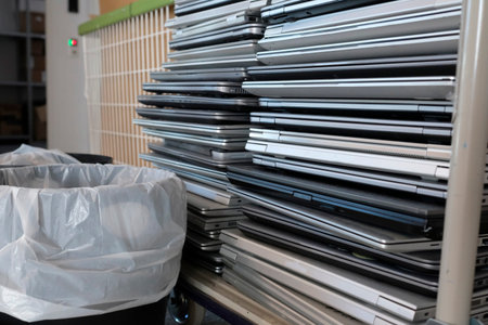 Electronic waste - stack of laptops to be discarded