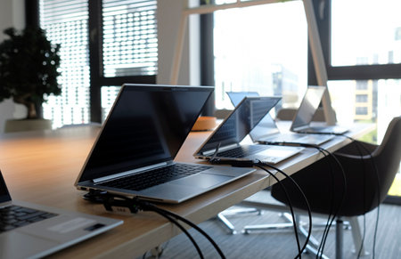 Row of laptops being prepared and set up for new employees in a companyの写真素材