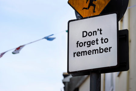 Road sign with the words "Don't forget to remember" written on itの写真素材
