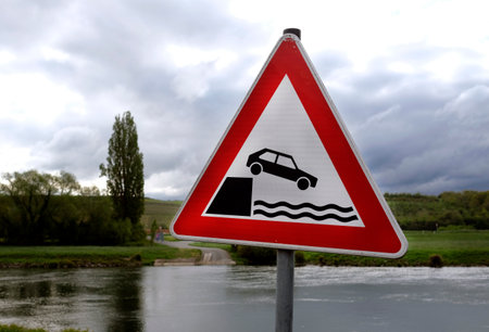 Road sign warning of driving into the waterの写真素材