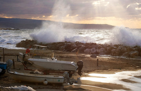 Dramatic sky at the coast of Pizzo, Italy, with waves breaking at the shore