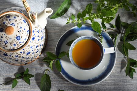 teapot and cup of herbal tea with nerbsの写真素材