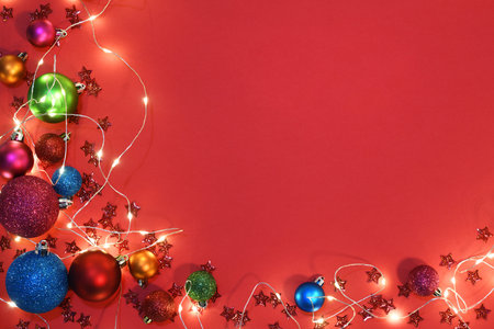 colorful christmas baubles on red background