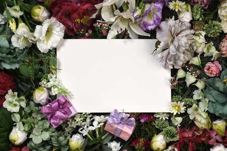 Greeting card template with gifts and beautiful flowersの写真素材