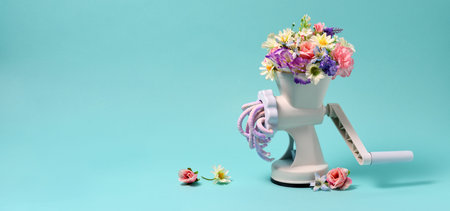 Conceptual image of meat grinder and flowers