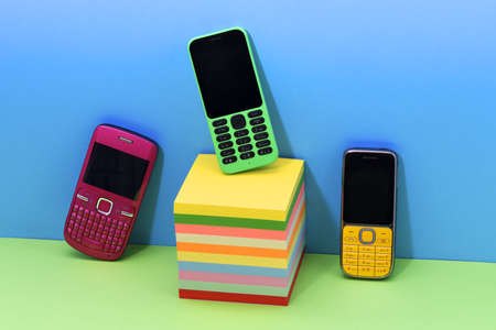 Arrangement of bright colored retro mobile telephonesの写真素材