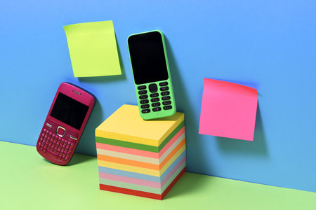 Arrangement of vintage mobile telephones and adhesive notes