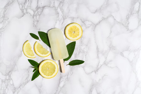 Lemon ice pop on marble table