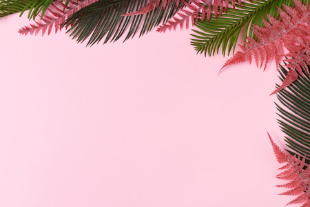 Frame of tropical leaves on pink backgroundの写真素材