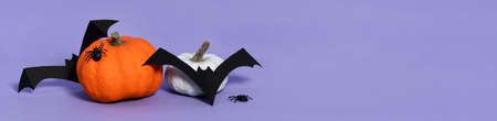 Arrangement of pumkins, ghosts, bats and spiders on violet backgroundの写真素材