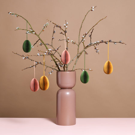 Vase with willow branches and Easter decoration