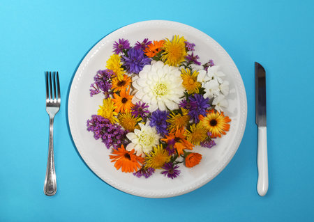 Plate with multi colored flowers on a blue background