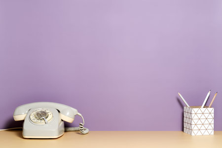 Vintage telephone and container with pencilsの写真素材