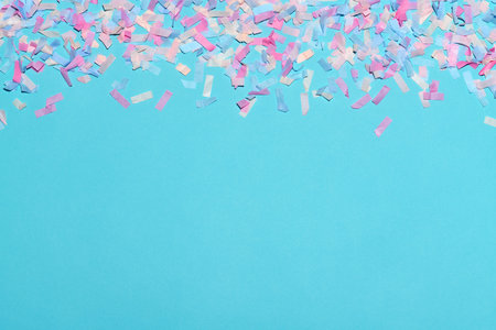 Multi colored confetti on a light blue background