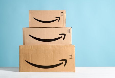Group of Amazon cardboard boxes on a light blue background. Bergamo, Italy, 15 December 2022.のeditorial素材