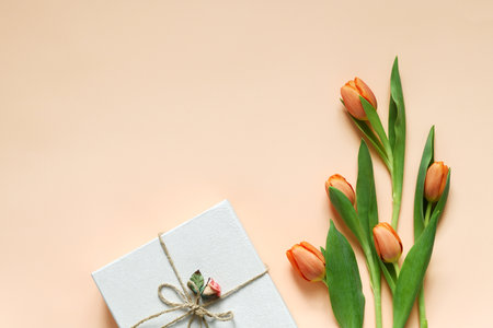 Pastel colored composition of orange tulips and decorated boxの写真素材