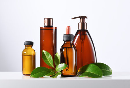 Set of brown cosmetic products with green leavesの写真素材