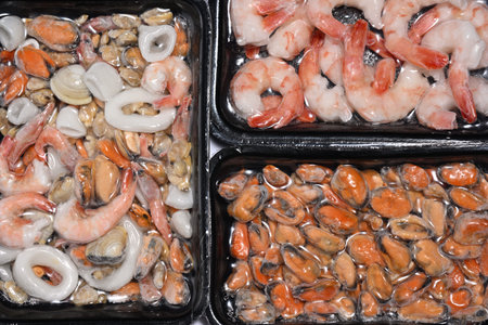 Plastic packages with seafood close upの写真素材