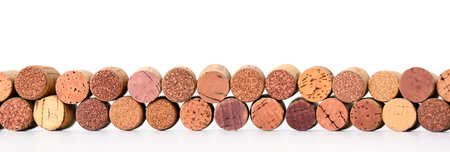 Border of assorted used wine corks on whiteの写真素材