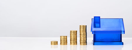 House mortgage financial concept. Blue house with coins