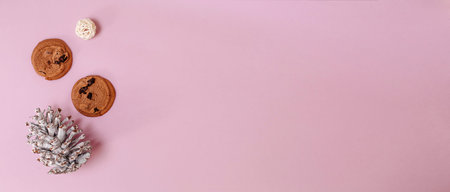 Christmas composition. Cookies, fir cones and balls of thread on a pink background. Flat lay, top...
