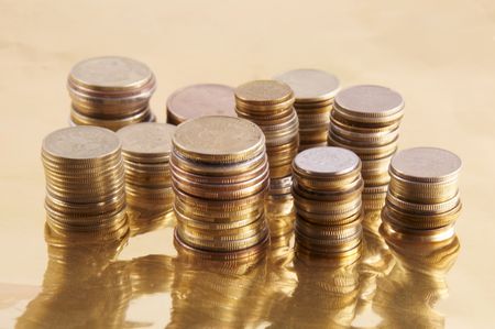 	coins on a gold backgroundの写真素材