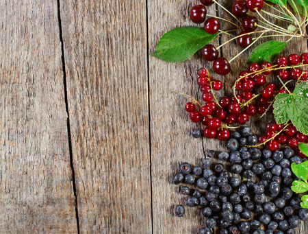 Juicy summer berries border. On a wooden surface.の写真素材