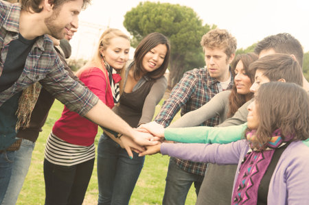 A group of Multiracial student whit hands on stack