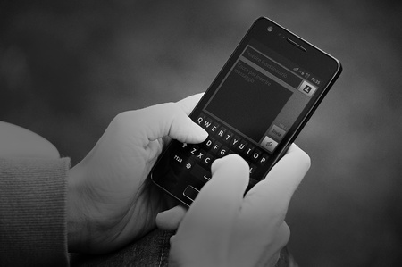 Textin on black mobile phoneの写真素材