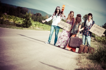 Hippie Group Hitchhiking on a Countryside Road,Italyの写真素材