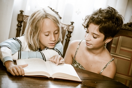 Portraits of young childs reading a book ,Italyの写真素材