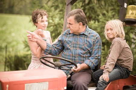 Adult Farmer with Children on Tractor,Italy