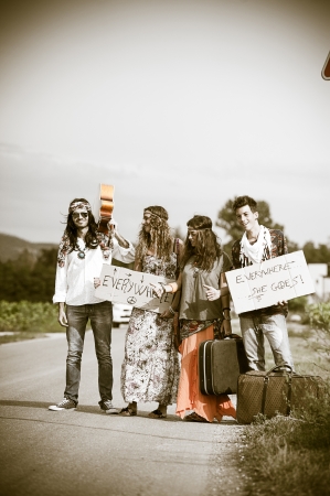 Hippie Group Hitchhiking on a Countryside Road,Italyの写真素材