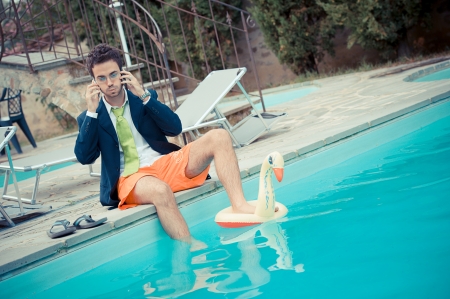 Funny Young Businessman with SwimmingTrunks next to the Poolの写真素材