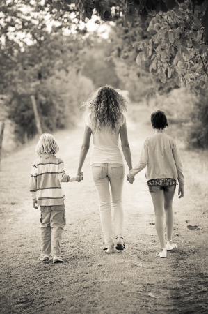 Beautiful Young Woman with Two Children Outside,Italyの写真素材