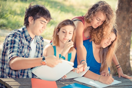 Teeneger students working together at park, Italyの写真素材