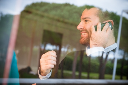 A man receive some happy news during a phone callの写真素材