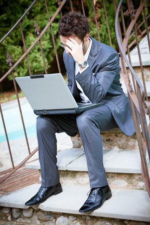 Tired Man Businessman overworking outdoors,Italyの写真素材