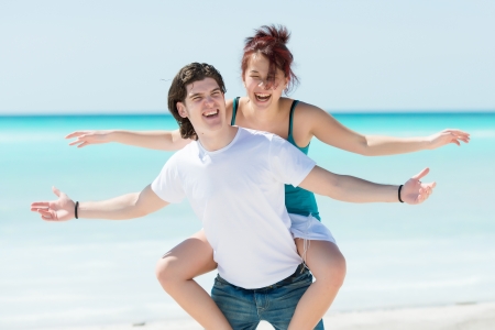 Portrait of a happy young couple having fun on the beach ,summerの写真素材