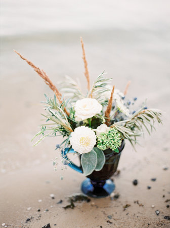 Blue flower vase staying on the sand beach, closeupの写真素材