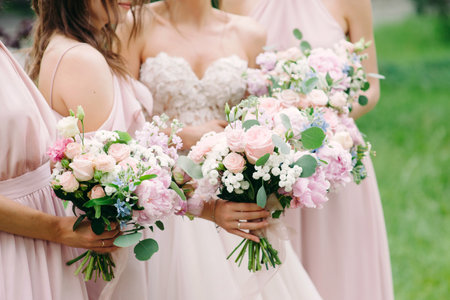 Bridesmaid's bouquets, wedding bouquets close up. Stylish wedding. Contemporary fashion wedding trends. Elegant beautiful style. Modern wedding concept. Bridesmaids holding wedding bouquets outdoor. Happy wedding concept.の写真素材