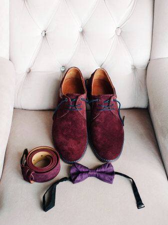 Burgundy suede shoes, belt and purple bow tie, fancy wedding, groom's accessories, male style and luxury fashion concept, close up, flat layの写真素材