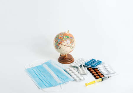 Stop global infection. Viral disease prevention, treatment. Globe, mask and medicines. Coronavirus, COVID-19 outbreakの写真素材