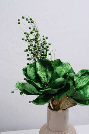 Tender bouquet of green flowers in ivory trendy vase. Interior floral decoration. Valentines day gift idea.の写真素材