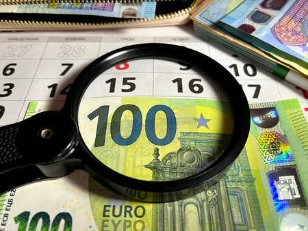 Magnifying glass on different Euro banknotesの写真素材