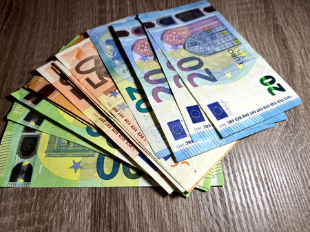 Euro banknotes of different denominations on a wooden background. The concept of thriftの写真素材